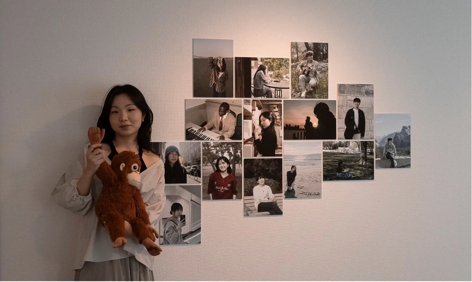 Chaeni standing beside a wall of portraits